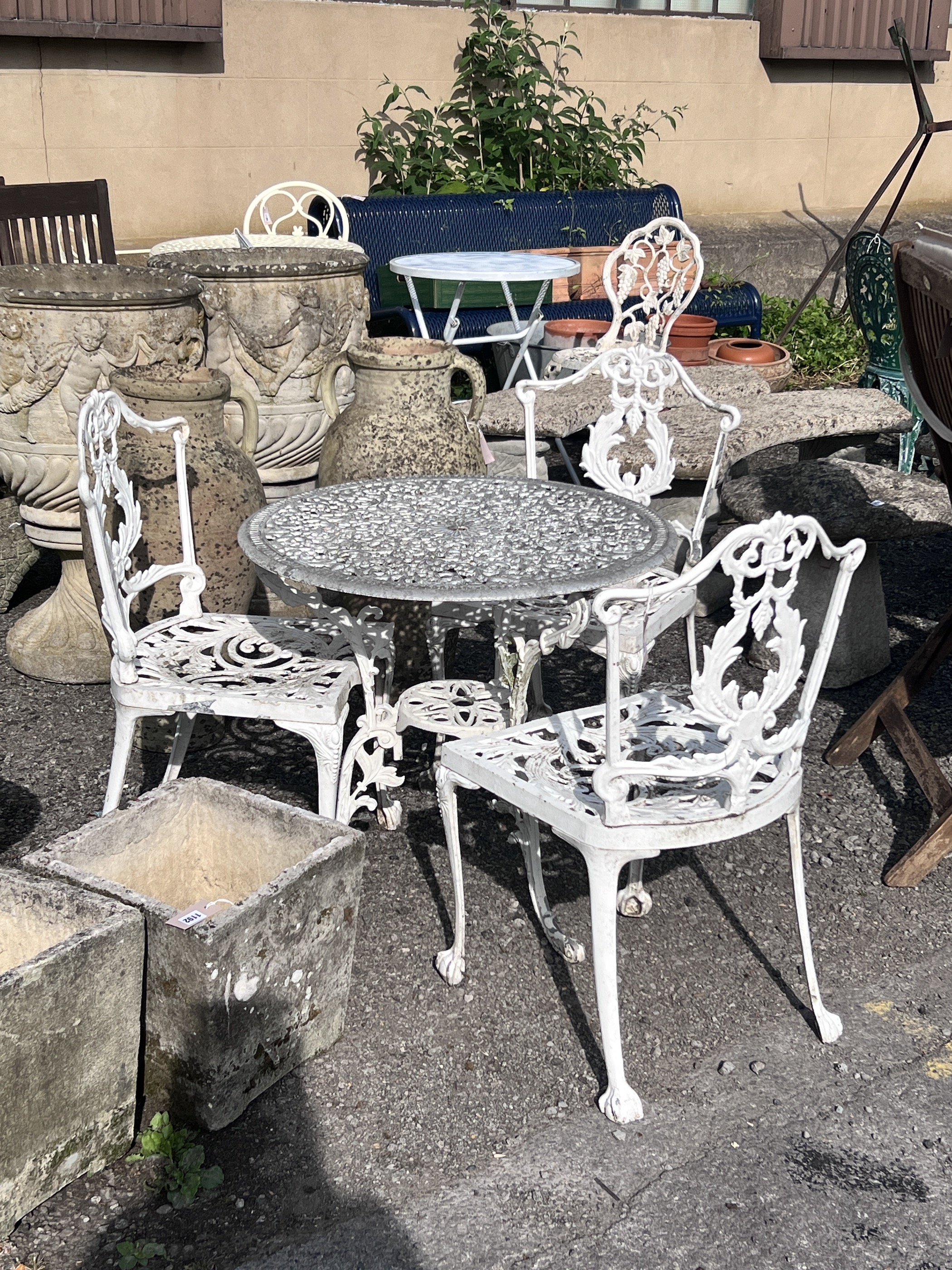 A Victorian style circular painted aluminium garden table, diameter 72cm, height 65cm, and three chairs